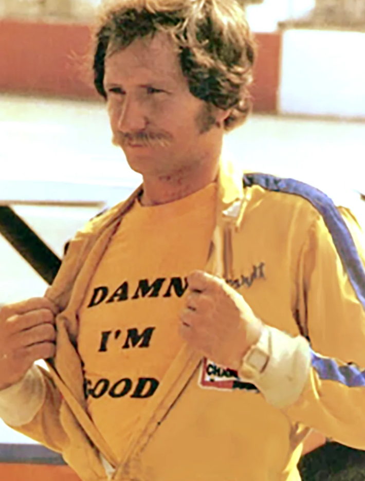 A man wearing a yellow shirt with the text "DAMN'T I'M GOOD" is shown in the image.